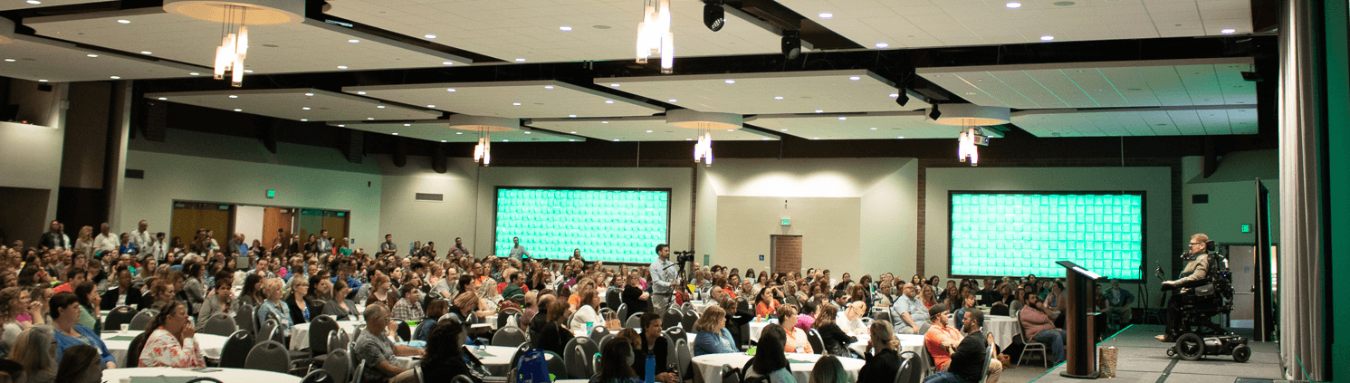 Image: Photo taken during the closing keynote speech a the Community Summit. Todd Stabelfedt addresses a packed crowd.