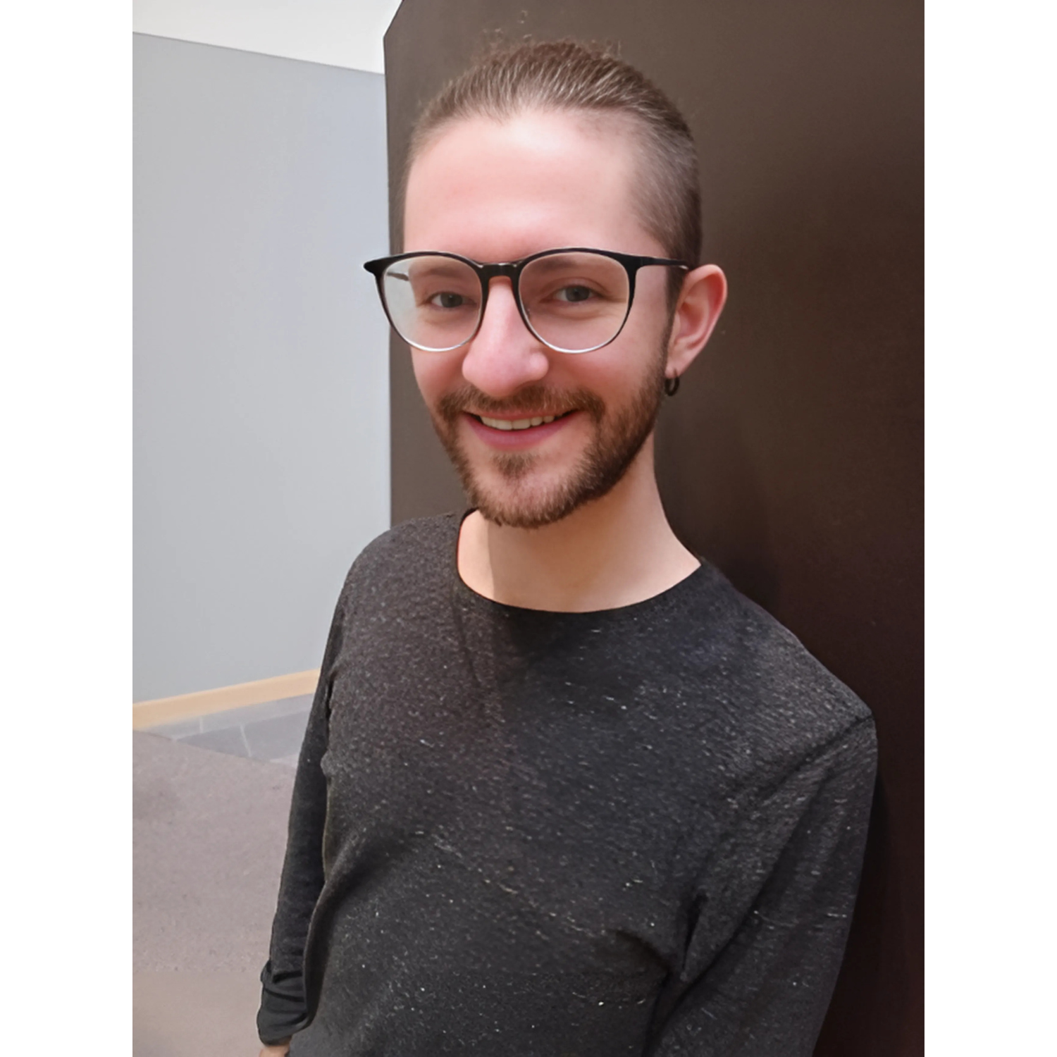 Image: Andrew Coltrin, white male with graying hair and glasses, smiling in his home office.