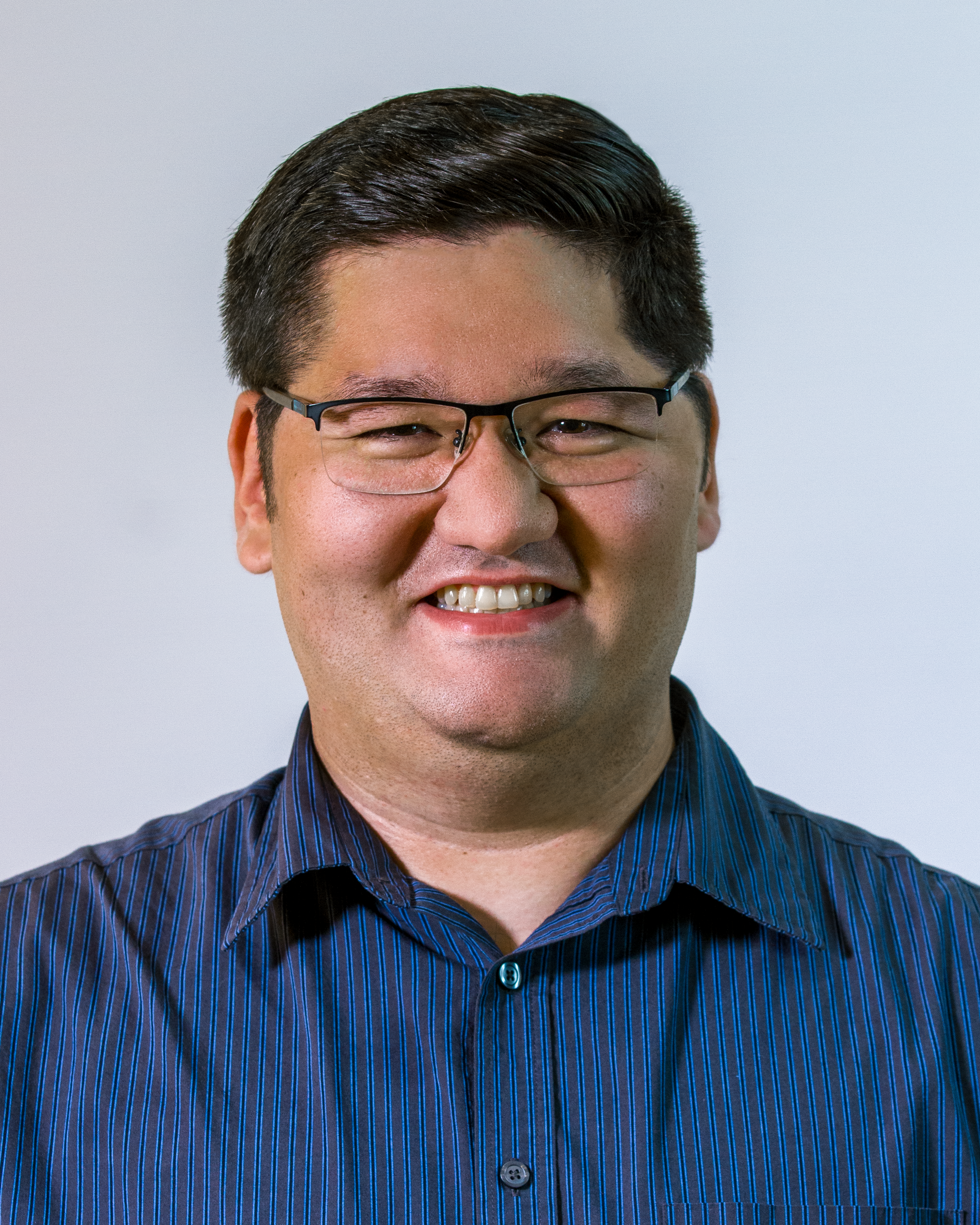 Image: Jeff Grace, a white man with dark-rimmed glasses and gray hair wearing a light blue vest over a dark shirt, smiles.