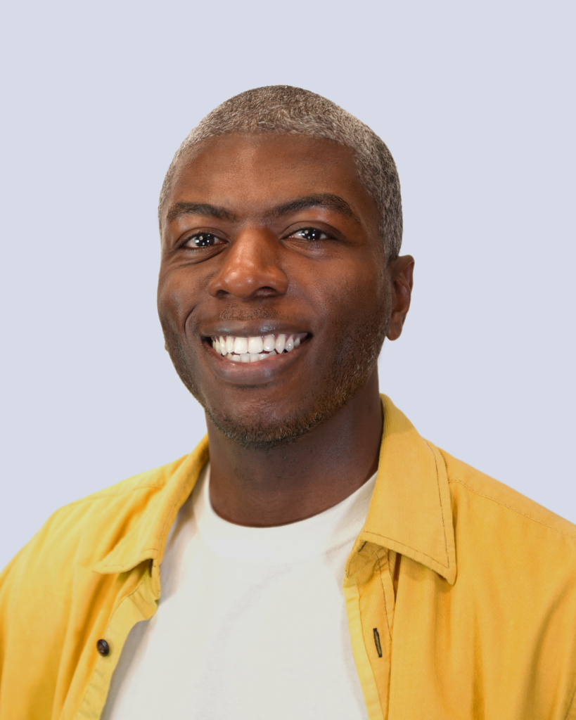 A photo of a man smiling at the camera.