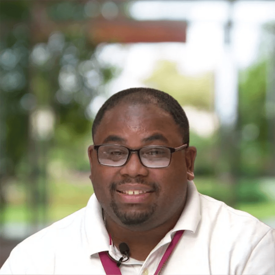 Dupree's headshot photo, man smiling at the camera wearing glasses